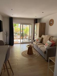 a living room with a couch and a table at Studio cosy a 500m de la plage in Fréjus