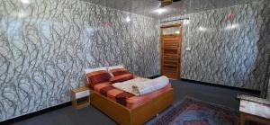 a bedroom with a couch in a room with a wall at Shangrella Hotel Malam Jabba in Malam Jabba +30 photos