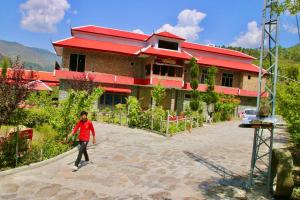 a man is standing in front of a building at Shangrella Hotel Malam Jabba in Malam Jabba
