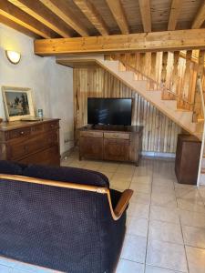 a living room with a couch and a television at La Digeonne in Chabeuil