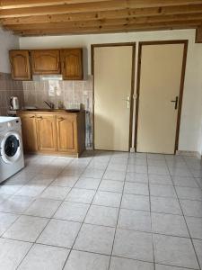 a kitchen with two doors and a tile floor at La Digeonne in Chabeuil