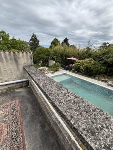 a swimming pool in front of a house at La Digeonne in Chabeuil