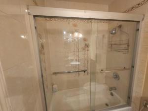 a shower with a glass door in a bathroom at Urban Retreat -Suite B in San Jose