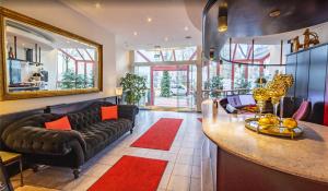 a living room with a couch and a table at Hotel Mozart in Traunreut