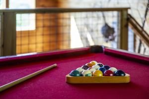 a tray of billiard balls on a pool table at A Tree Top View home in Gatlinburg