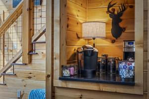 a log cabin with a shelf under the stairs at A Tree Top View home in Gatlinburg +77 photos