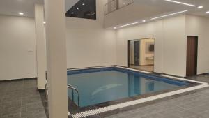 an empty swimming pool in a building at Nicolas Farm & Resort in Mansar