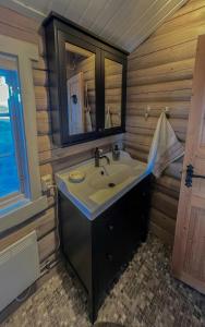 a bathroom with a sink and a mirror at Cozy, Magical Mountain Cabin With Trails in Etnedal +20 photos