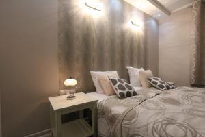 a bedroom with a bed with pillows and a table at Modern in Zgorzelec