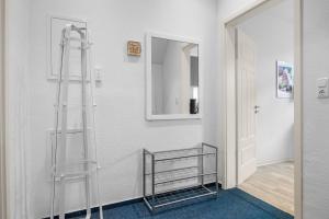 a glass shower in a bathroom with a mirror at Ferienwohnung Edo Wiemken in Jever