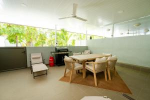a dining room with a table and chairs at Chic poolside haven 3BR steps from the beach in Cap Malheureux