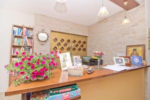 a room with a desk with flowers on it at Pansion Irini in Ouranoupoli