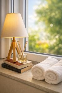 a lamp sitting on a table next to a window at MARY'S HOUSE The lux terrace in Tripoli +57 photos