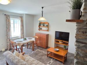 a living room with a couch and a table at Apartamentos Turísticos Rosa in Ribadeo