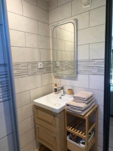 a bathroom with a sink and a mirror at Studio cosy a 500m de la plage in Fréjus