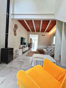a large living room with a fireplace and a couch at La Llar de la Font in Barraca de Aguas Vivas