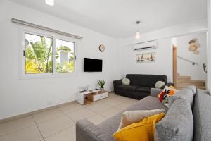 a living room with a couch and a tv at Nissini Villas in Ayia Napa