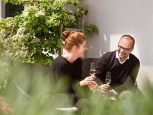 a man and a woman holding glasses of wine at Novotel Suites Berlin City Potsdamer Platz in Berlin
