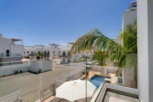 an apartment with a large balcony with a swimming pool at Nissini Villas in Ayia Napa