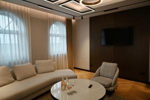 a living room with a couch and a table and a tv at Djordjevic Estate Winery in Lapovo