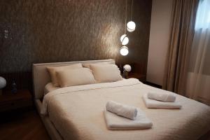 a bedroom with a bed with two towels on it at Djordjevic Estate Winery in Lapovo
