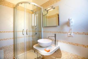 a bathroom with a sink and a shower at Triskell Camere & Relax in Castelluzzo