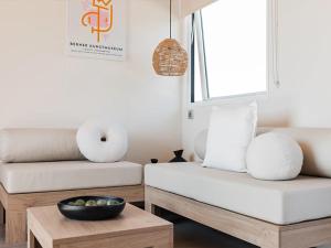 a living room with two white couches and a bowl on a table at Camping 4 étoiles - ccbg0ic in Saint-Éloy-les-Mines
