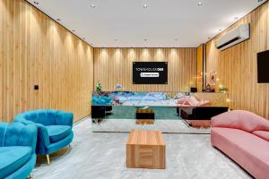 a lobby with blue and pink chairs and a table at Super Townhouse OAK Chandigarh Ambala Expressway Gazipur Formerly Troy Resorts and Wellness in Zirakpur