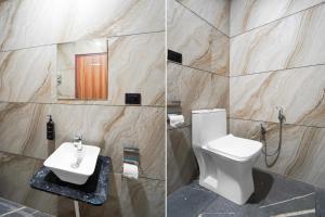a bathroom with a white toilet and a sink at Super Townhouse OAK Chandigarh Ambala Expressway Gazipur Formerly Troy Resorts and Wellness in Zirakpur