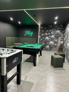 a billiard room with a pool table and a ball wall at Skorzęcin Apartamenty Orla in Skorzęcin