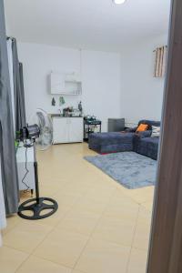 a living room with a fan on a floor at The Comfort Den in Kampala