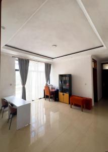 a living room with a table and chairs at Plenty Residence by Splendid Hotel, Retreat & Group Stay Near Kigali in Runda