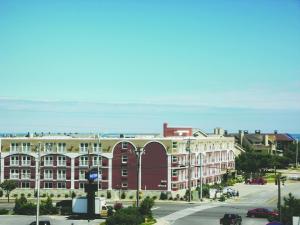 a view of a street with a large building at Gold Leaf Hotel of Dewey in Dewey Beach