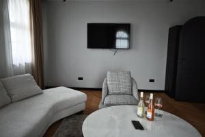a living room with a couch and a table and a chair at Djordjevic Estate Winery in Lapovo