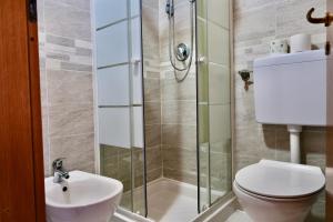 a bathroom with a shower with a toilet and a sink at The Courtyard Retreat in Brunate +27 photos