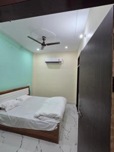 a bedroom with a bed and a ceiling fan at Divine House in Lucknow +6 photos