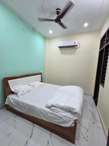 a bedroom with a bed with a ceiling fan at Divine House in Lucknow