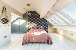 a bedroom with a bed in a room with skylights at The Grand Weave House in Shipley