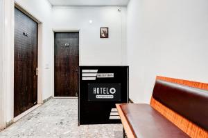 a bench sitting in a room with a door at Super Hotel O Panipat Railway Station Formerly Atithi in Pānīpat
