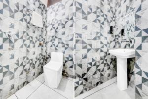 a bathroom with a toilet and a sink at Super Hotel O Panipat Railway Station Formerly Atithi in Pānīpat