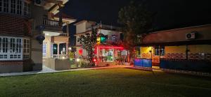 a night view of a building with lights at London House Resort in Birātnagar