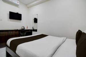 a bedroom with a bed and a desk and a television at Super Collection O Park Street Metro Station Formerly Park Platinum in Kolkata +23 photos
