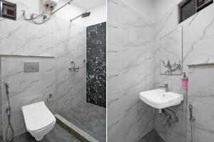 a white bathroom with a sink and a toilet at Super Collection O Park Street Metro Station Formerly Park Platinum in Kolkata