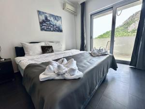 a bedroom with a bed with a towel on it at WEST GATE free parking & wi-fi in Sutomore +87 photos