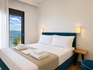 a bedroom with a bed with towels on it at Life's Moments in Limenaria