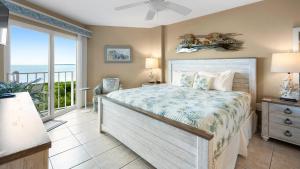 a bedroom with a bed with a view of the ocean at 4409 Ocean Pointe Suites in Tavernier +29 photos