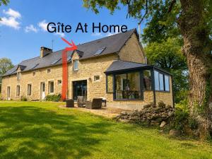a house with a gift at home next to it at At Home in Cruguel