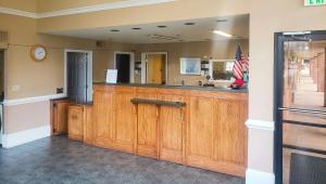 a room with a bar with a sink and a mirror at Magnuson Hotel Marietta in Marietta