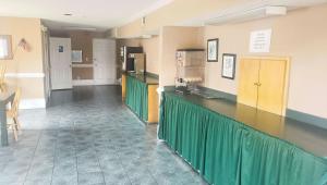 a large room with a counter and a kitchen at Magnuson Hotel Marietta in Marietta