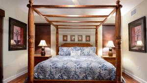 a bedroom with a bed with a wooden canopy at 515 Mariners Club in Key Largo +49 photos